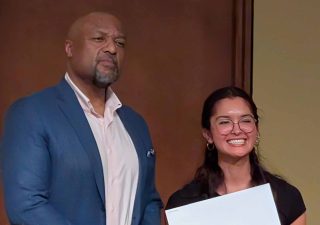 Annika Webb Maurer (awardee) receiving the Hilldale Undergraduate Research Scholarship, pictured with Provost Charles Isbell.